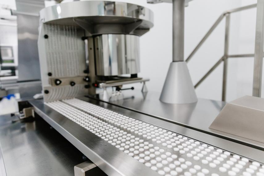 Compressed tablets moving along the production conveyor